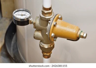 Brass pressure limiting valve with pressure gauge on white pipe Sandringham Melbourne
